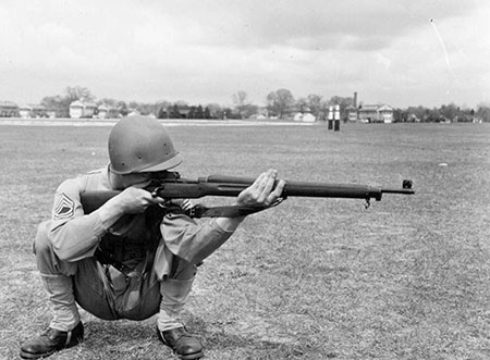 WWII Soldier comfortably firing a rifle from a deep resting squat